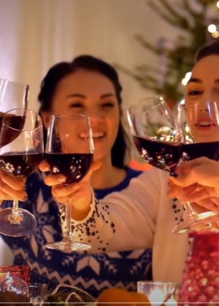 people clinking glasses of wine