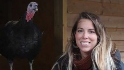 woman stands with rescue turkey