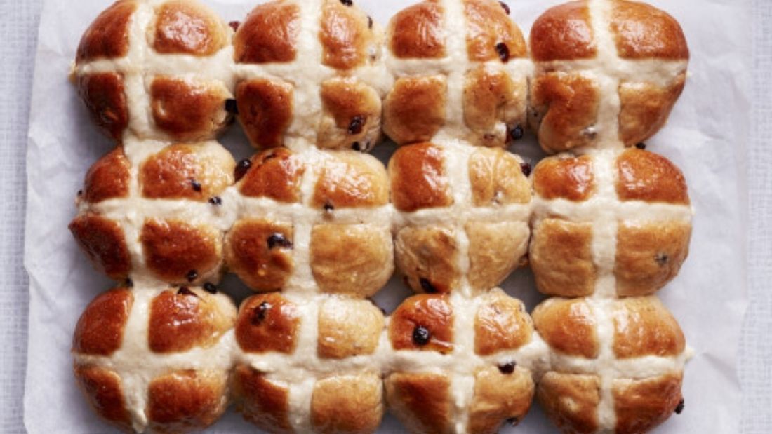 Vegan hot cross buns on white background