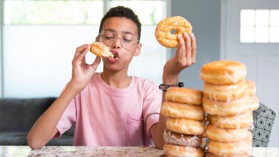 boy eating doughnuts