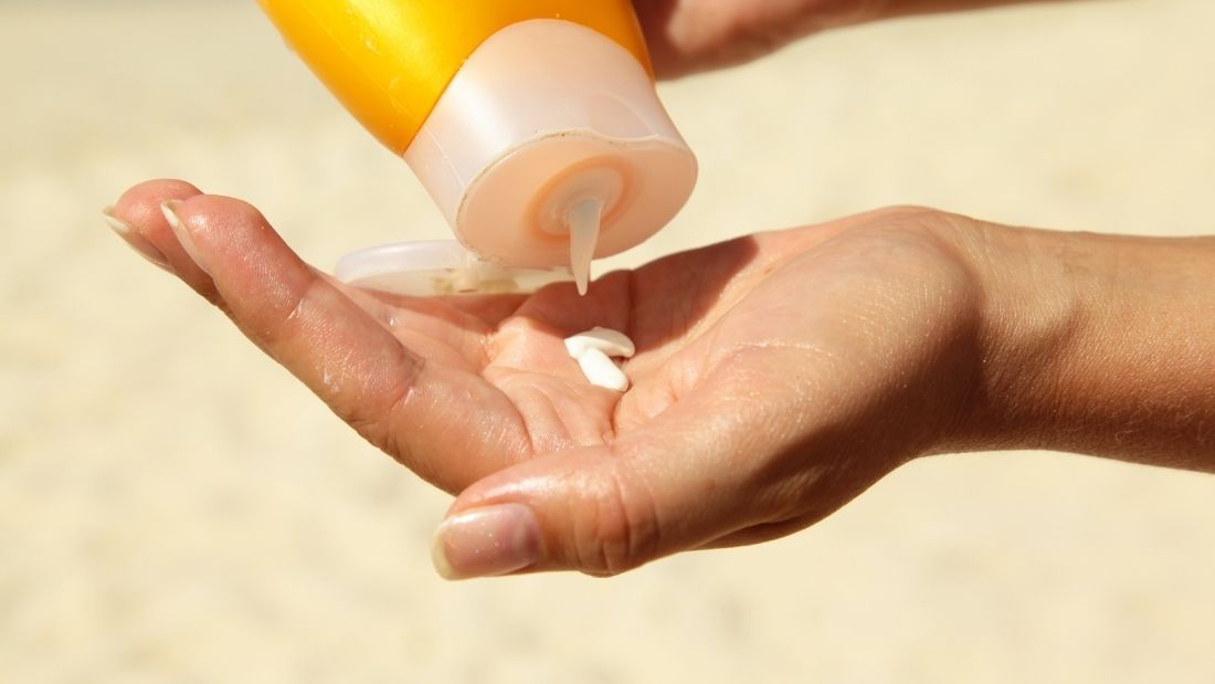 A hand with suncream on it