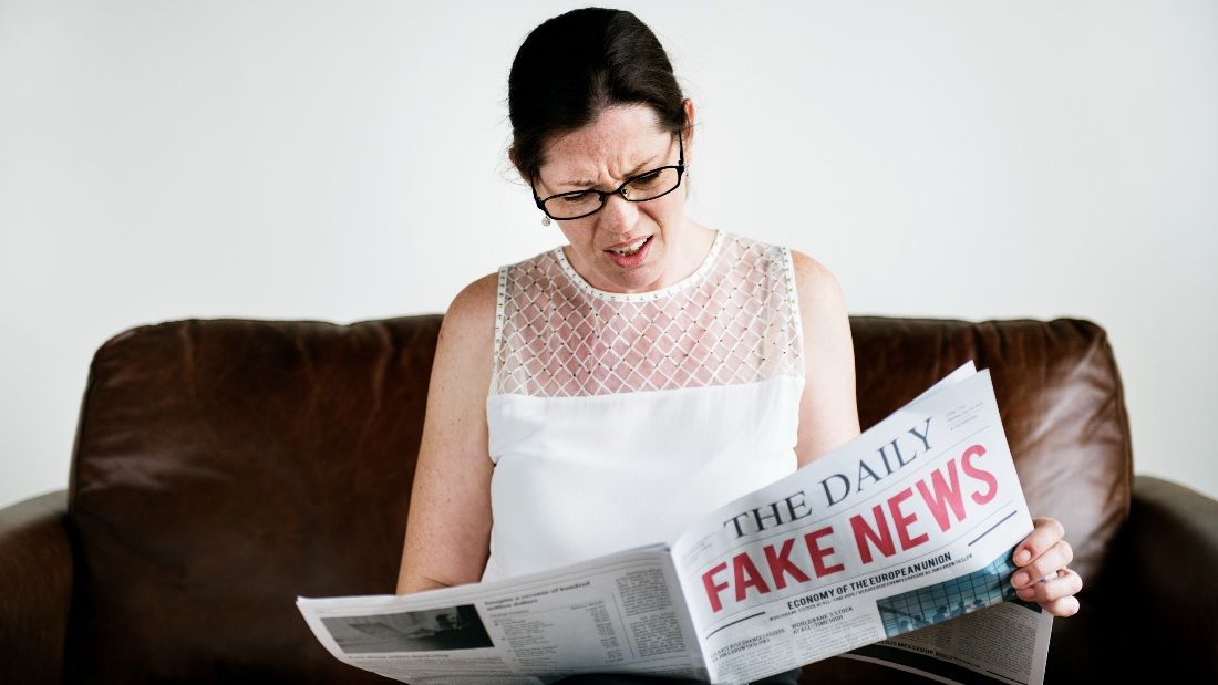 woman reading fake news