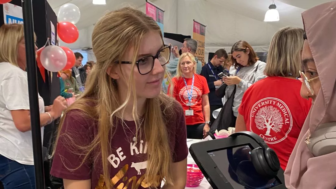 Viva! campaigner talks with student at Plymouth freshers fayre event