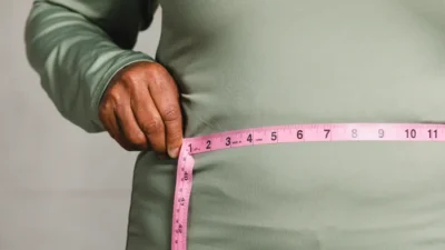 close up of person measuring waist