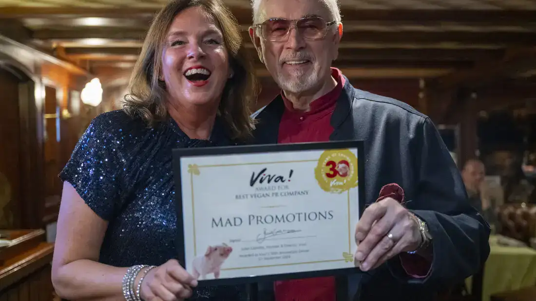 Karin Ridgers of Mad Promotions accepting the Best Vegan PR award. With Peter Egan.