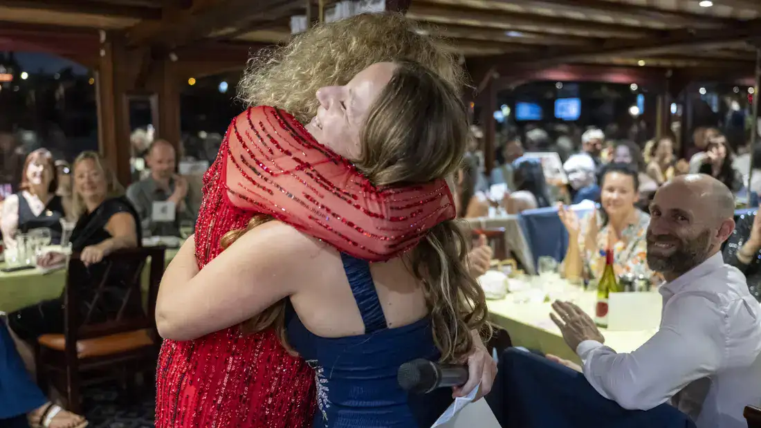 Laura Hellwig and Juliet Gellatley hug as Laura accepts an award.