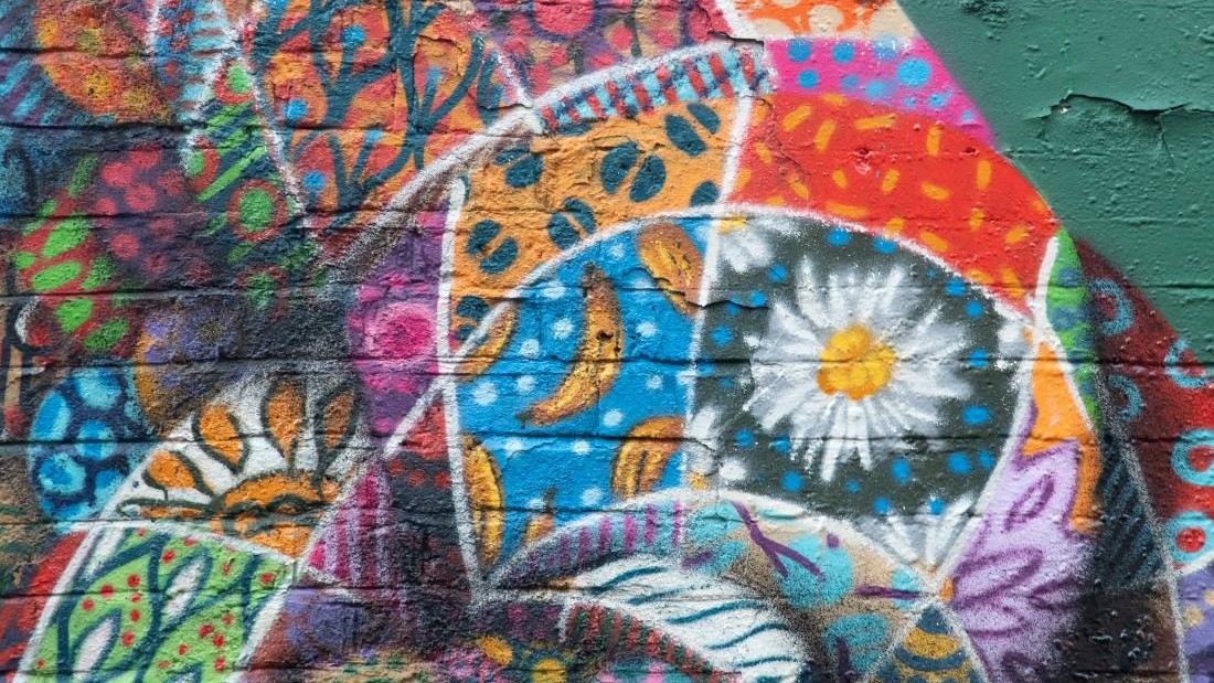 An upclose shot of colourful mural artwork in a patchwork style